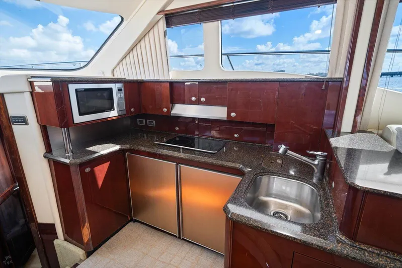 Vivid Imagination Yacht Photos Pics Luxurious kitchen interior of 2007 Sea Ray 52 Sedan Bridge yacht with modern amenities.