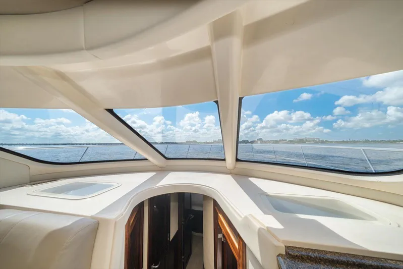 Vivid Imagination Yacht Photos Pics Interior view of 2007 Sea Ray 52 Sedan Bridge yacht with ocean and sky through windows.