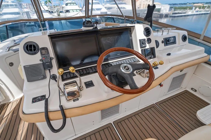 Vivid Imagination Yacht Photos Pics 2007 Sea Ray 52 Sedan Bridge helm with wooden steering wheel and modern navigation equipment.