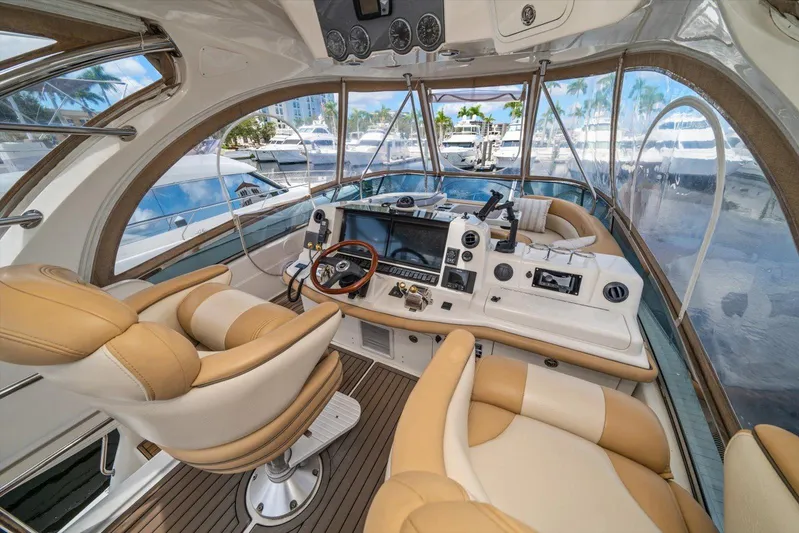 Vivid Imagination Yacht Photos Pics Luxurious 2007 Sea Ray 52 Sedan Bridge yacht interior with modern helm and plush seating.