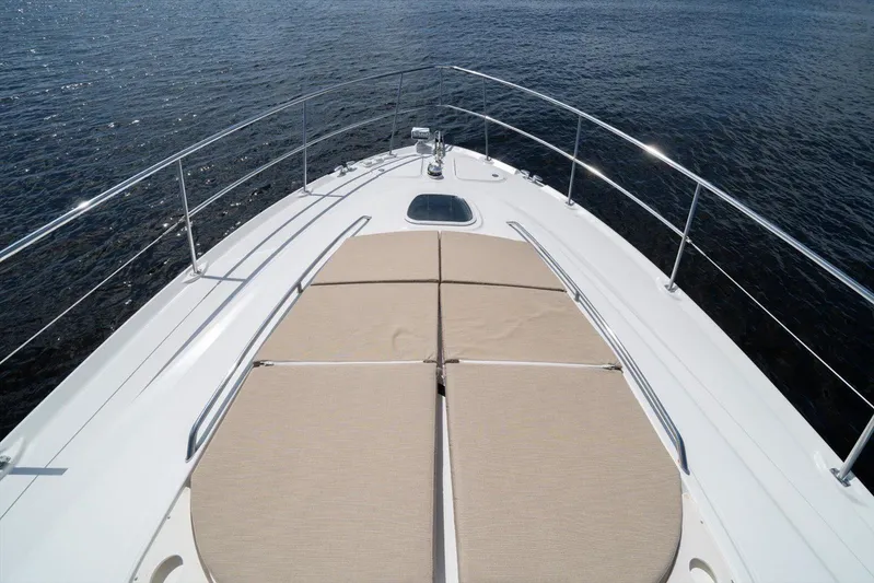 Vivid Imagination Yacht Photos Pics 2007 Sea Ray 52 Sedan Bridge yacht bow with sunpads on calm water.