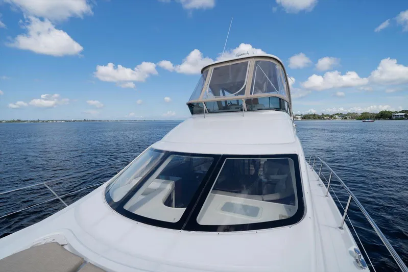 Vivid Imagination Yacht Photos Pics 2007 Sea Ray 52 Sedan Bridge yacht on calm water under a blue sky.