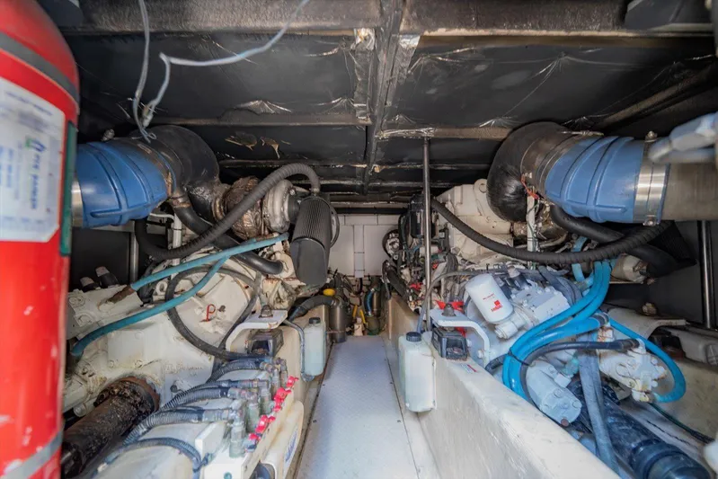 Vivid Imagination Yacht Photos Pics Engine room of a 2007 Sea Ray 52 Sedan Bridge yacht, showcasing mechanical components.