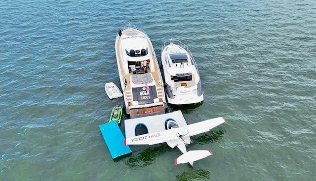 Volk Yacht Photos Pics Aerial view of 2009 Lazzara LSX 75 yacht with seaplane and jet ski on water.