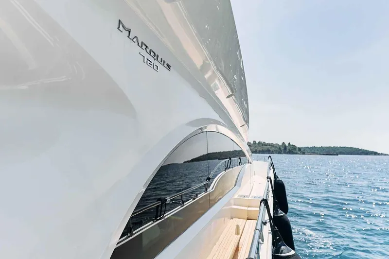 Markisia Yacht Photos Pics Luxurious 2010 Marquis 720 Flybridge yacht cruising on serene blue waters.