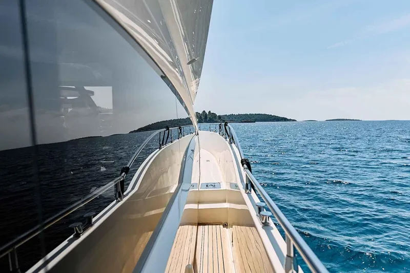 Markisia Yacht Photos Pics Luxurious 2010 Marquis 720 Flybridge yacht cruising on serene blue waters.