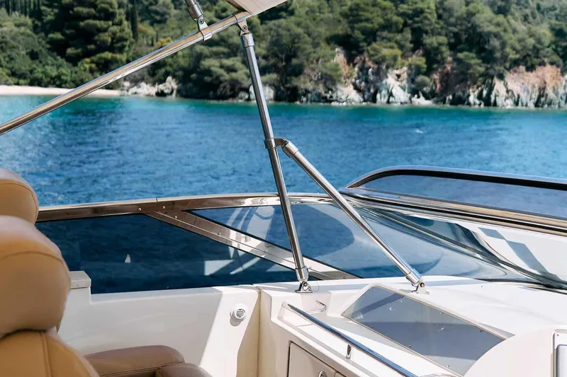 Markisia Yacht Photos Pics Luxurious 2010 Marquis 720 Flybridge yacht cruising on serene blue waters.