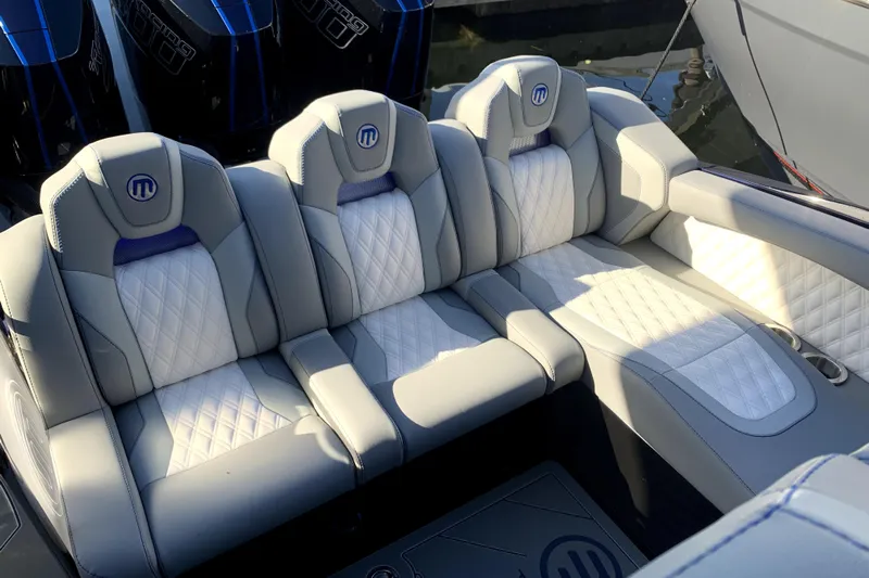  Yacht Photos Pics Luxurious seating in 2026 Mystic Powerboats M3800, featuring elegant quilted upholstery.