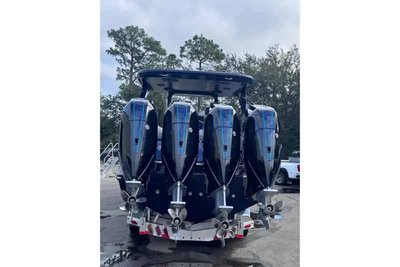  Yacht Photos Pics 2026 Mystic Powerboats M3800 with four powerful outboard engines, parked outdoors.
