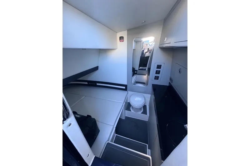  Yacht Photos Pics Interior of 2026 Mystic Powerboats M3800, featuring compact cabin with bed and toilet.
