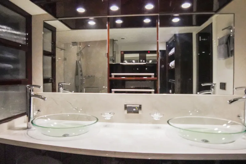 Volk Yacht Photos Pics Luxurious bathroom in 2009 Lazzara LSX 75 yacht with dual glass sinks and modern fixtures.