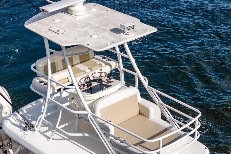  Yacht Photos Pics Boston Whaler 420 Outrage 2022 boat with upper deck seating and steering, on blue water.