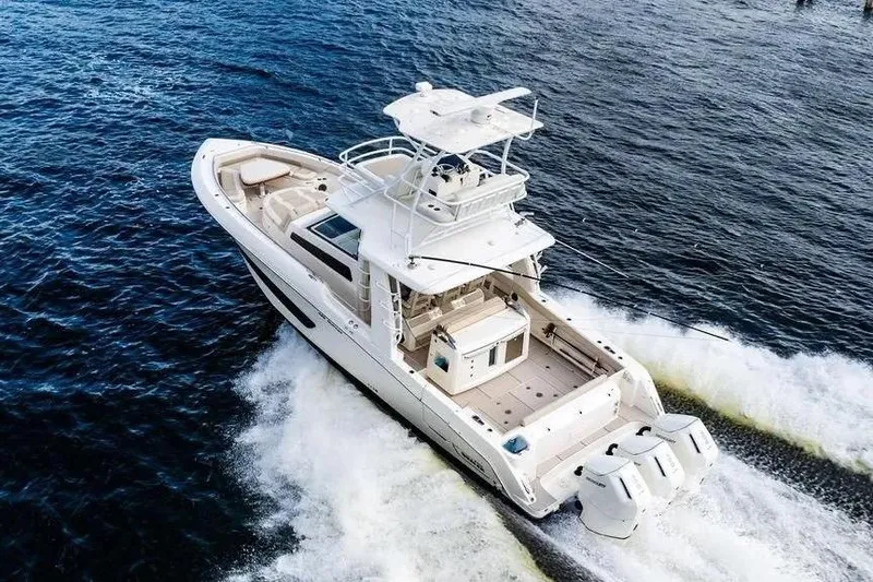  Yacht Photos Pics 2022 Boston Whaler 420 Outrage cruising on open water, showcasing sleek design and powerful engines.