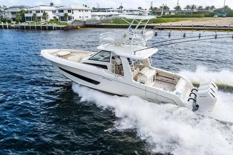  Yacht Photos Pics 2022 Boston Whaler 420 Outrage cruising on water, showcasing luxury and performance.