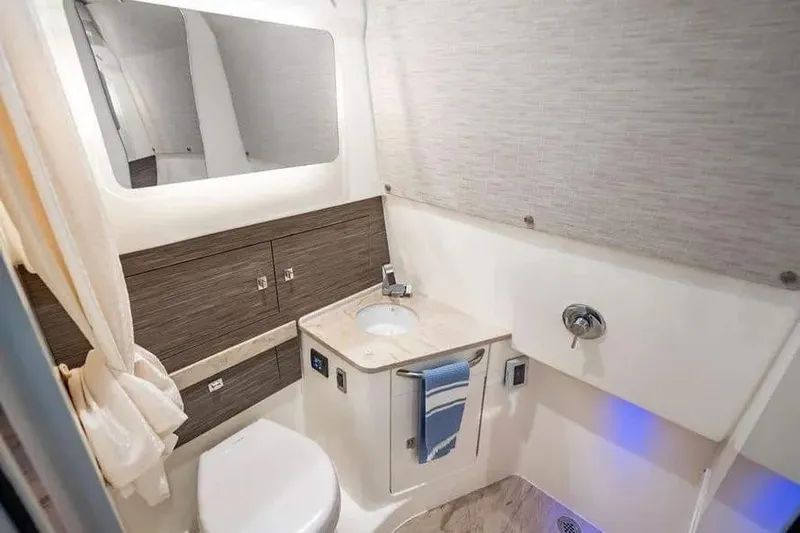  Yacht Photos Pics Luxurious bathroom interior of 2022 Boston Whaler 420 Outrage boat, featuring modern amenities.