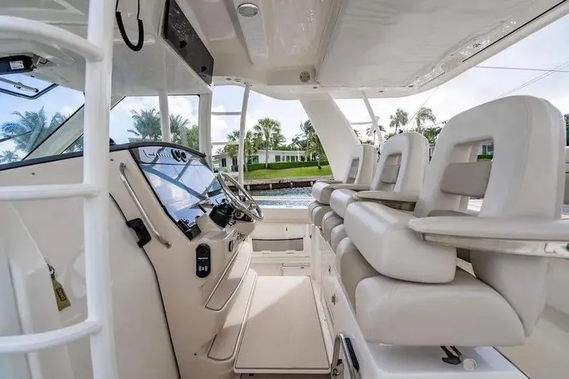  Yacht Photos Pics Interior of 2022 Boston Whaler 420 Outrage boat with luxurious seating and modern controls.
