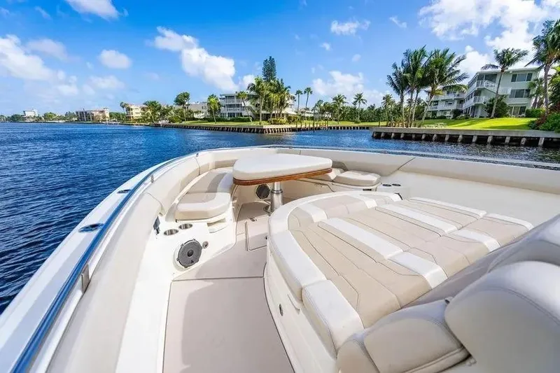  Yacht Photos Pics 2022 Boston Whaler 420 Outrage boat interior with luxurious seating and scenic waterfront view.