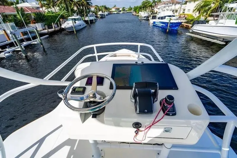  Yacht Photos Pics Helm of 2022 Boston Whaler 420 Outrage overlooking a scenic waterway.