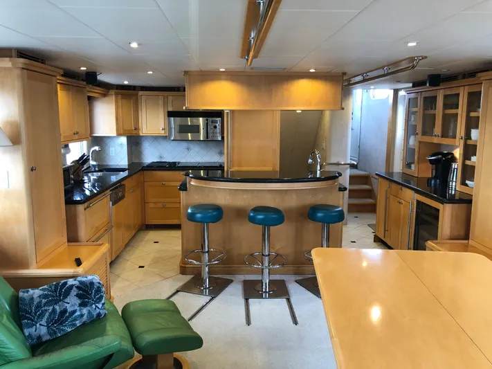 Evening Star Yacht Photos Pics Luxurious 2003 Cape Horn Trawler interior with modern kitchen and bar stools.