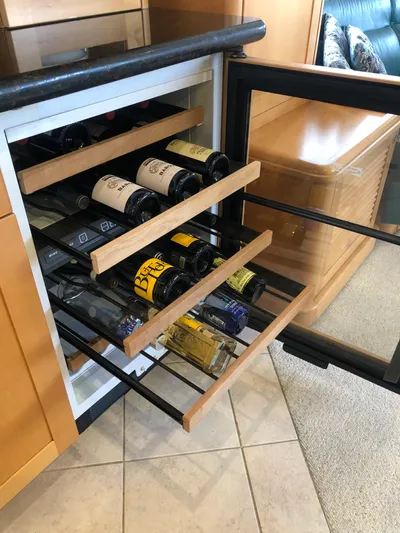 Evening Star Yacht Photos Pics Wine cooler with wooden shelves on a 2003 Cape Horn Trawler yacht.