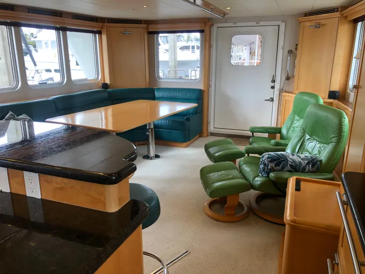 Evening Star Yacht Photos Pics Interior of 2003 Cape Horn Trawler with green seating and wooden accents.
