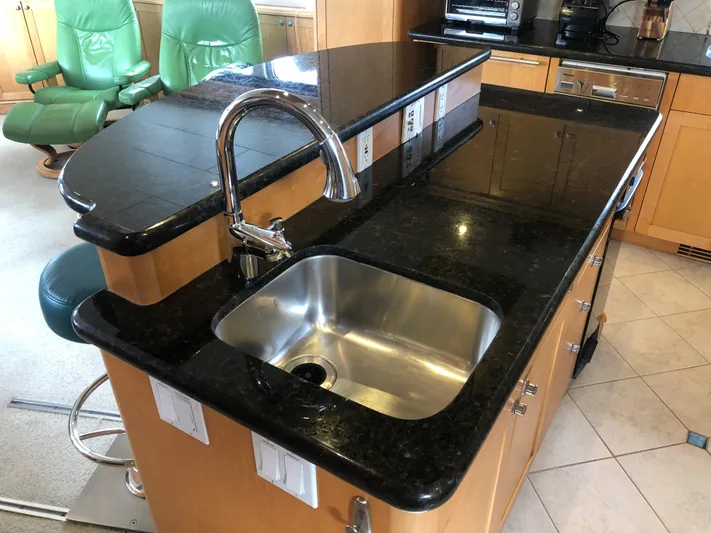 Evening Star Yacht Photos Pics Luxurious kitchen interior of 2003 Cape Horn Trawler with granite countertops and stainless steel sink.