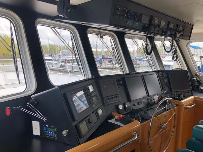 Evening Star Yacht Photos Pics 2003 Cape Horn Trawler helm with navigation equipment and steering wheel, docked at marina.