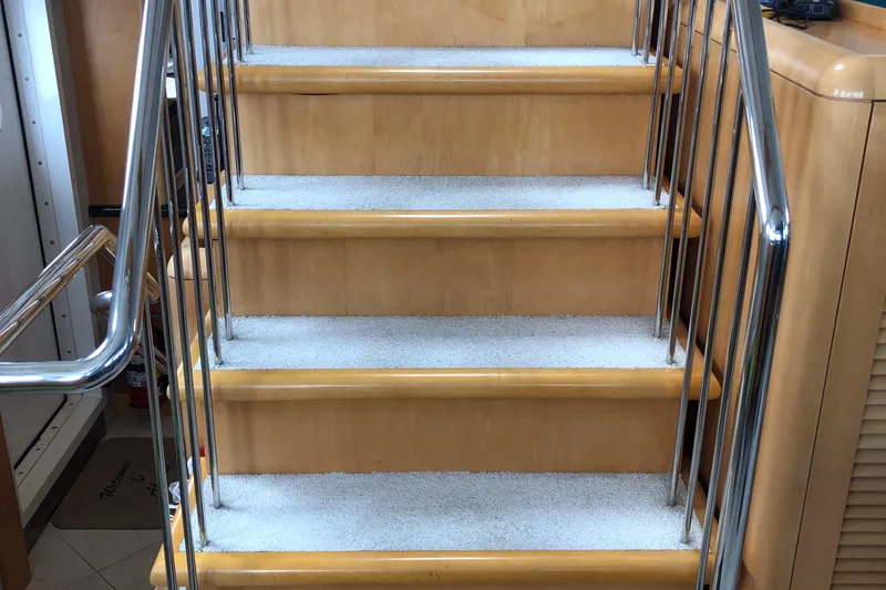Evening Star Yacht Photos Pics Staircase with wooden steps and metal railings inside a 2003 Cape Horn Trawler.