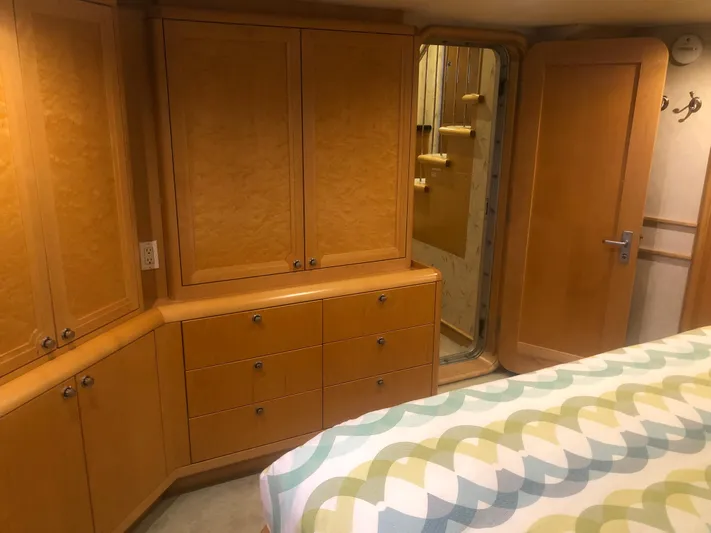 Evening Star Yacht Photos Pics Interior of 2003 Cape Horn Trawler with wooden cabinets and patterned bedspread.