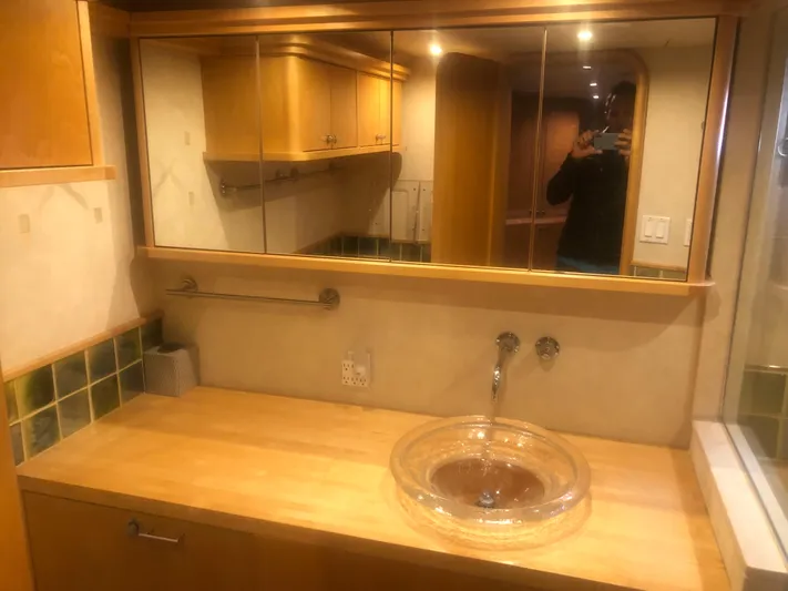 Evening Star Yacht Photos Pics 2003 Cape Horn Trawler bathroom with wooden cabinetry and glass sink.