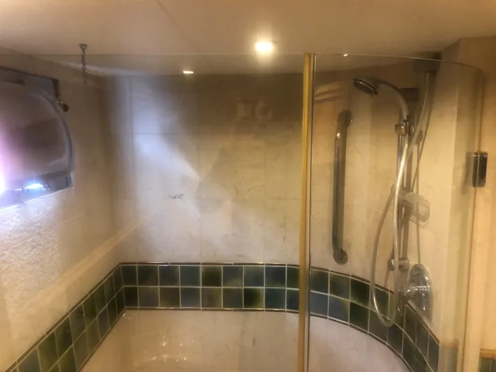 Evening Star Yacht Photos Pics Shower area in 2003 Cape Horn Trawler with glass door and modern fixtures.