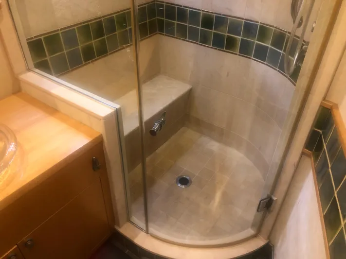 Evening Star Yacht Photos Pics Shower area in 2003 Cape Horn Trawler with glass door and tiled walls.