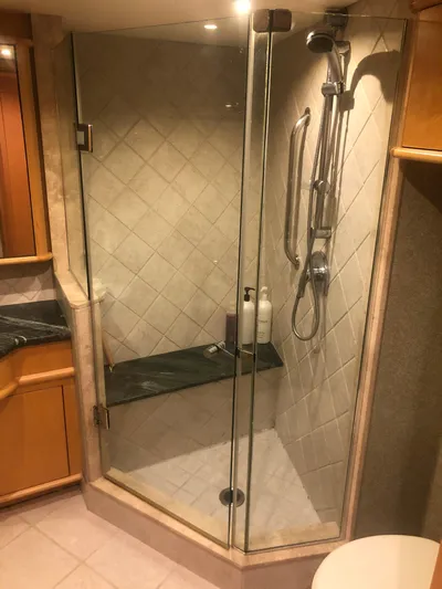 Evening Star Yacht Photos Pics Luxurious shower in a 2003 Cape Horn Trawler, featuring glass doors and modern fixtures.