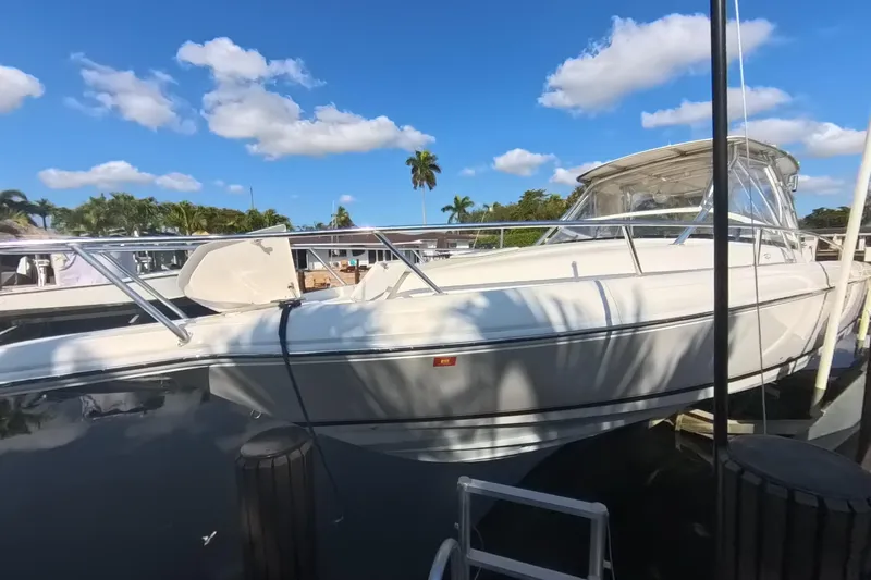  Yacht Photos Pics 2005 Intrepid 348 Walkaround boat docked under a clear blue sky.