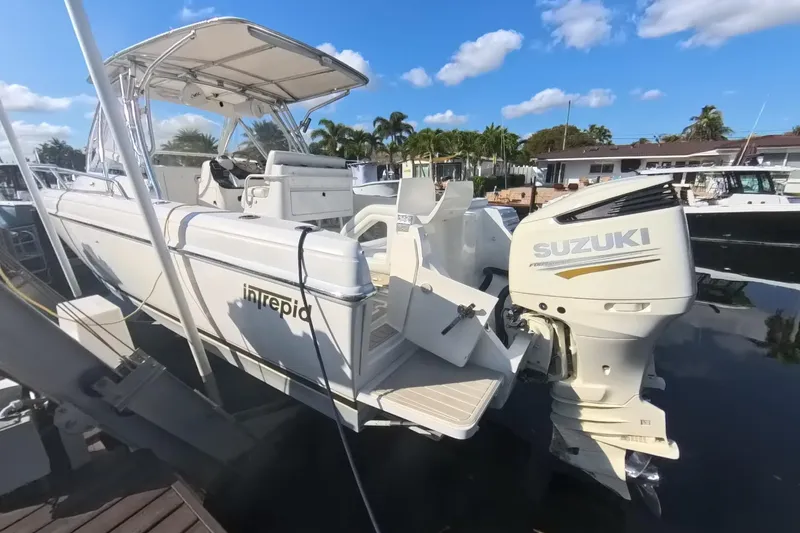  Yacht Photos Pics 2005 Intrepid 348 Walkaround boat with Suzuki outboard motor docked under clear skies.