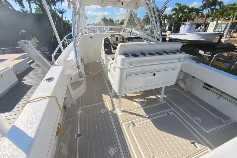  Yacht Photos Pics 2005 Intrepid 348 Walkaround boat interior with seating and helm, docked under sunny skies.