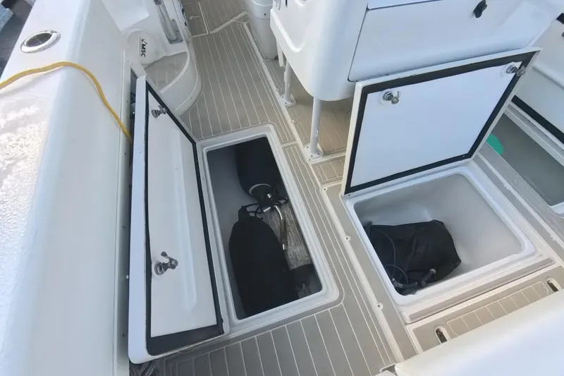  Yacht Photos Pics 2005 Intrepid 348 Walkaround boat deck with open storage compartments.