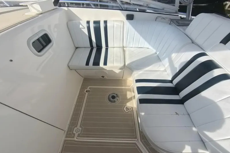  Yacht Photos Pics 2005 Intrepid 348 Walkaround boat interior with white and black striped seating.