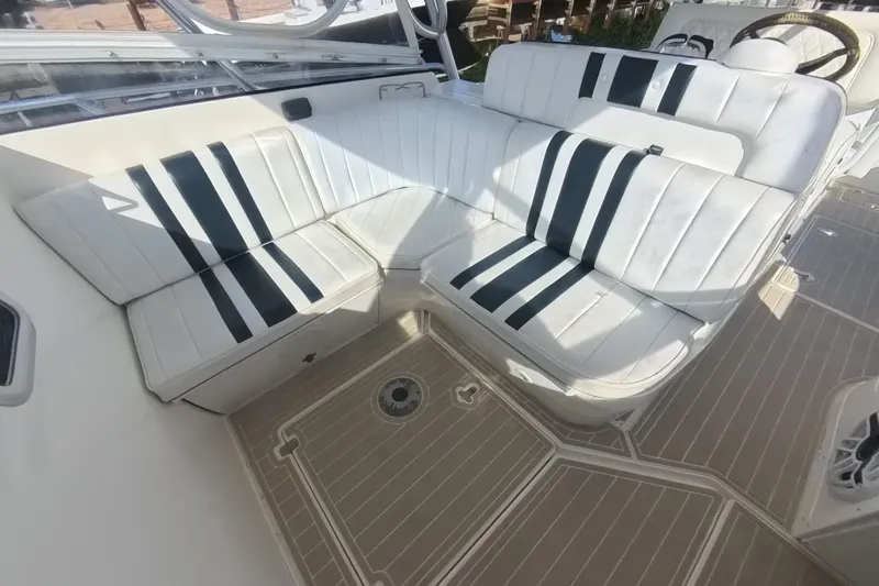  Yacht Photos Pics 2005 Intrepid 348 Walkaround boat interior with white and black striped seating.