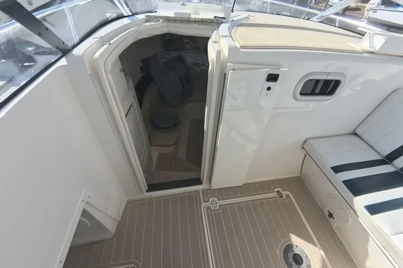  Yacht Photos Pics 2005 Intrepid 348 Walkaround cabin entrance with seating and deck view.