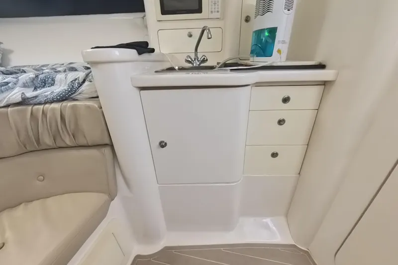  Yacht Photos Pics 2005 Intrepid 348 Walkaround cabin interior with kitchenette and seating area.