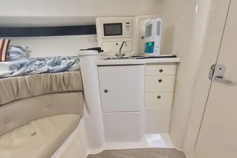  Yacht Photos Pics 2005 Intrepid 348 Walkaround cabin interior with kitchenette and bed.