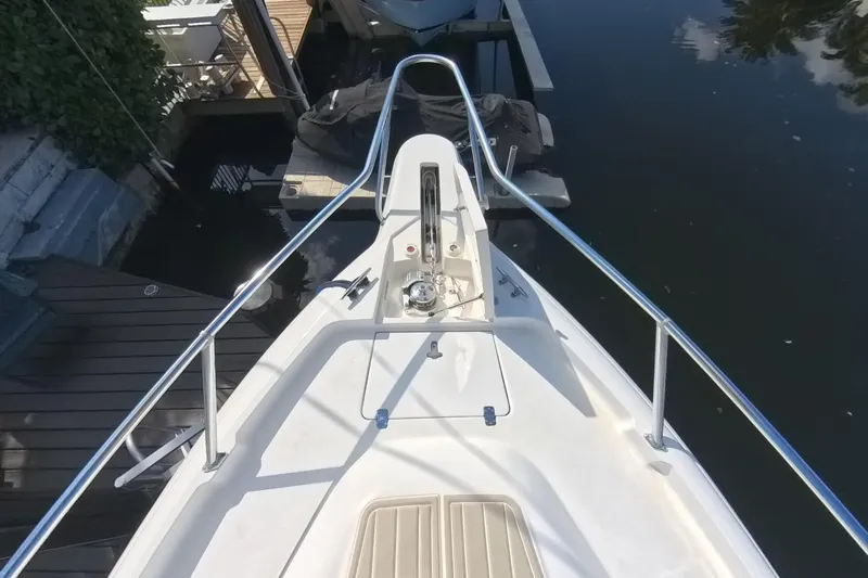  Yacht Photos Pics Bow view of 2005 Intrepid 348 Walkaround boat docked by the water.