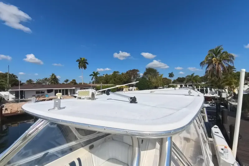  Yacht Photos Pics 2005 Intrepid 348 Walkaround boat docked under clear blue sky with palm trees.