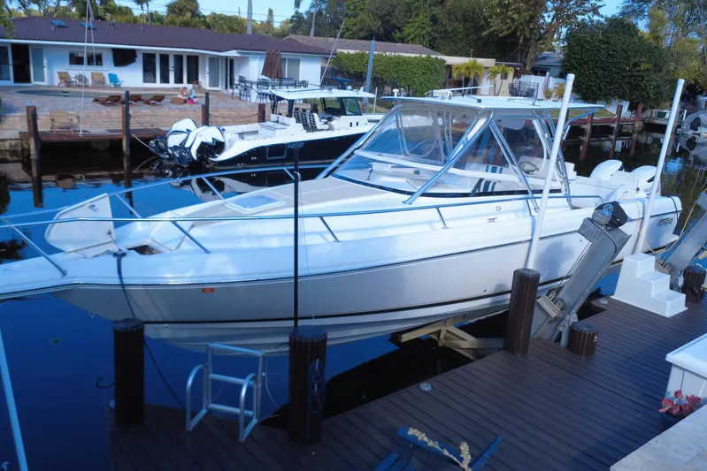  Yacht Photos Pics 2005 Intrepid 348 Walkaround boat docked at a marina, surrounded by calm water.