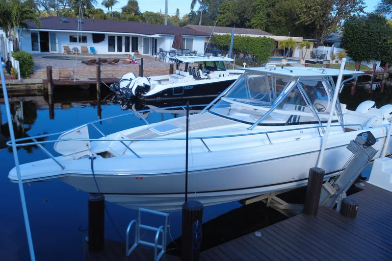  Yacht Photos Pics 2005 Intrepid 348 Walkaround boat docked near waterfront homes.