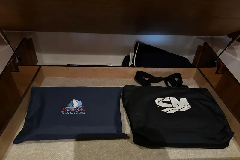 Big Blue Yacht Photos Pics Storage compartment in a 2010 Back Cove 37 yacht with branded bags.