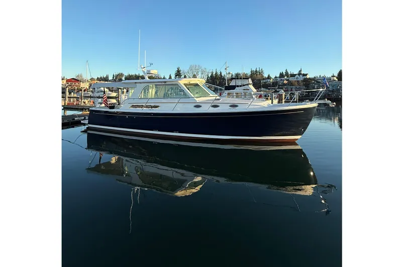 Big Blue Yacht Photos Pics 2010 Back Cove 37 yacht docked in serene marina under clear blue sky.