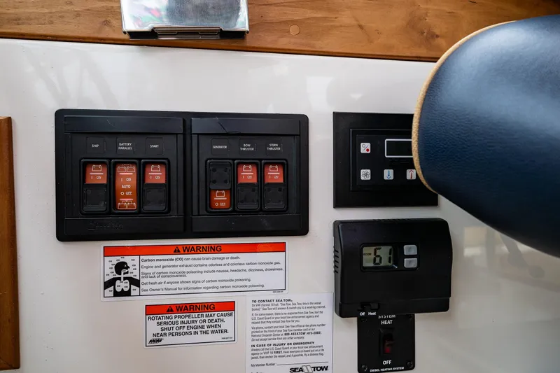 Big Blue Yacht Photos Pics Control panel of a 2010 Back Cove 37 boat with warning labels and switches.