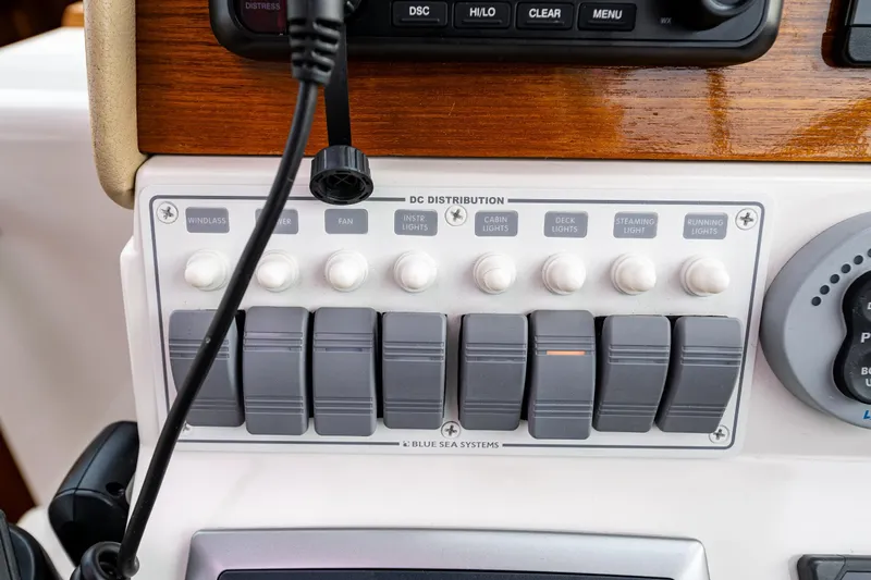Big Blue Yacht Photos Pics Control panel of a 2010 Back Cove 37 boat with labeled switches and buttons.